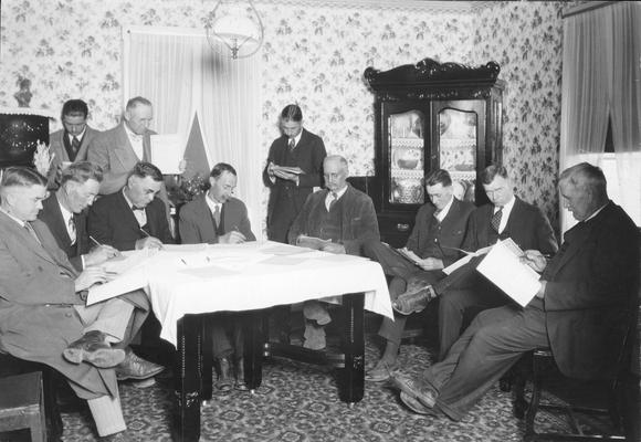 Farm group leaders in a meeting at a farm house residence
