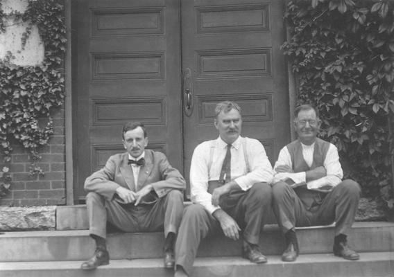 Engineering Faculty on steps of Mechanical Hall, left to right, Louis E. Nollau, Mechanical Engineering, Joseph Dicker, Superintendent of Shops, unidentified individual, Photographer, Unknown