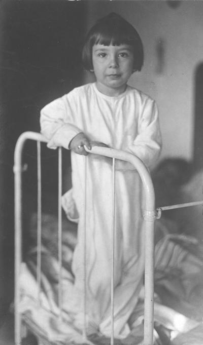 Young child standing on a bed