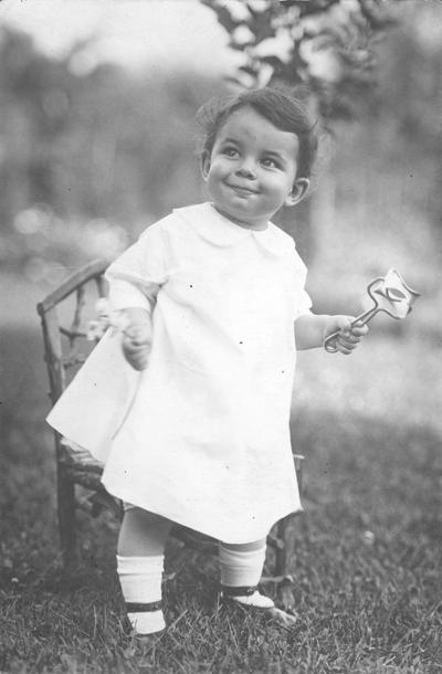 Young girl holding rattle