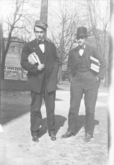 Two men holding books