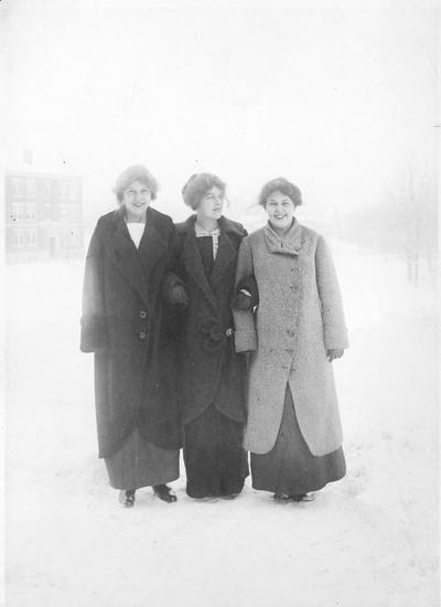 Three young women standing in the snow, circa 1915