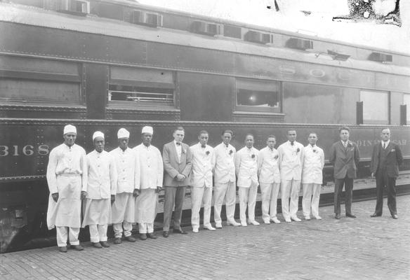 Exterior of Southern Railway dining car number 3618 with group of African American staff and railroad officials in foreground