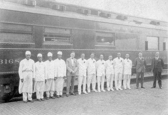 Exterior of Southern Railway dining car number 3618 with group of African American staff and railroad officials in foreground