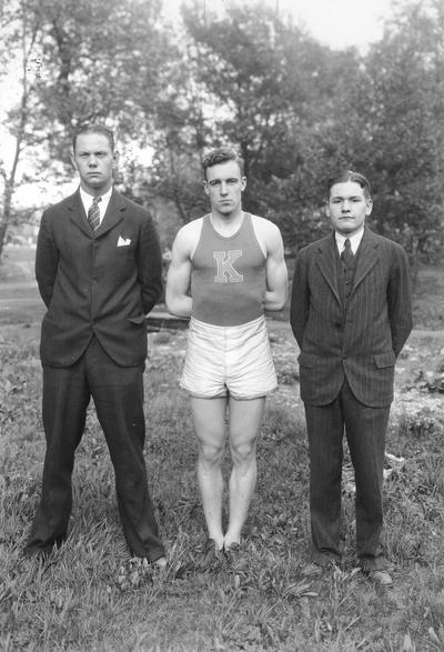 Track, athlete and two other men