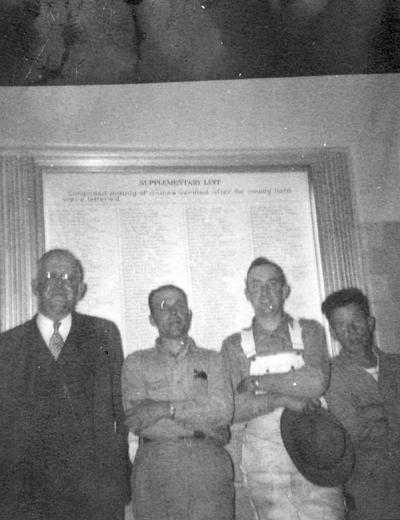 Ezra Gillis, Registrar and Professor of Education, 1910 - 1937 and Director of Bureau of Source Materials in Higher Education, 1937 - 1956 with men working on the lettering of the war dead list in Memorial Coliseum, circa 1950, Photographer, Unknown