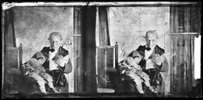 Glass negative of Dr. Peter holding A.M. Peter as a small child on his lap, 1860s