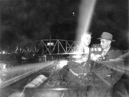 Double exposure of two men and a bridge