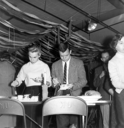 Students preparing sandwiches at a party