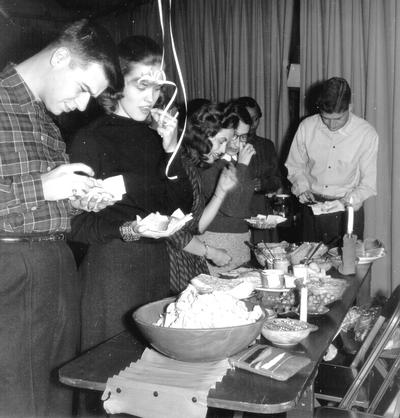 Students getting snacks and hors d'oeuvres at party (Tom Anderson, Donna Reed)