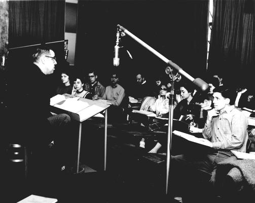 A professor speaking to students in a studio classroom; 