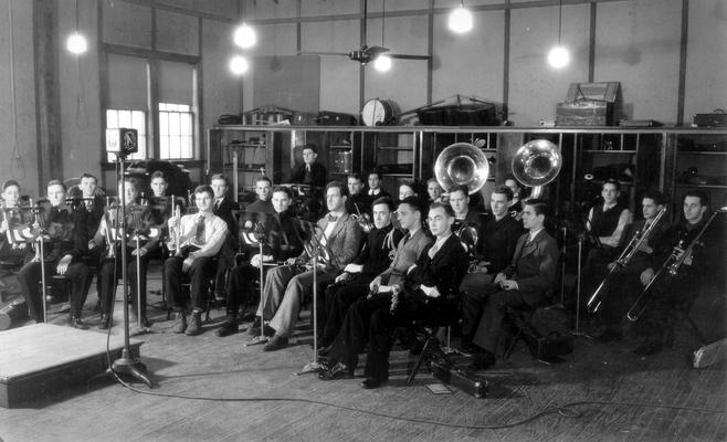 Band in band room, seated and ready to play: microphone positioned next to conductors stand