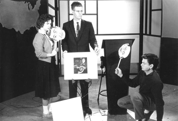 Shirley Boyd and Dr. Doug Schwartz  around photo on card: two persons holding cartoon like faces on sticks