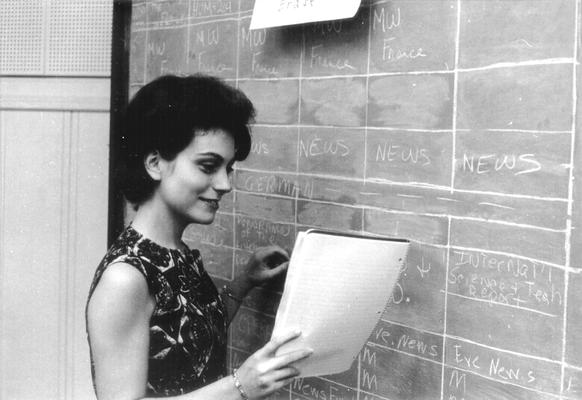 Woman scheduling programs at blackboard