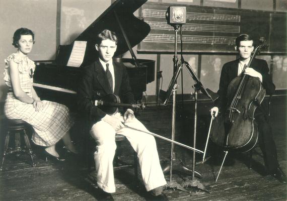 Three musicians (one female, two males) posed for photo in WHAS/UK studio; condenser microphone between violinist and cellist