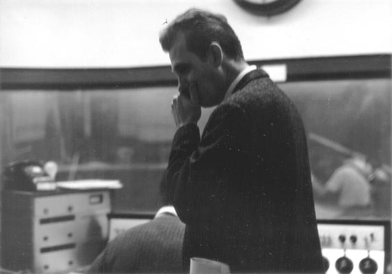 Unidentified man standing in control booth