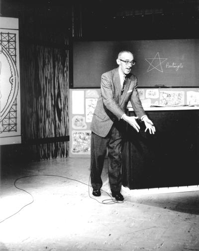 Dr. Arthur L. Cooke lecturing on camera for televised English Literature course