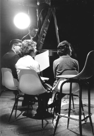 Three persons sitting in TV studio