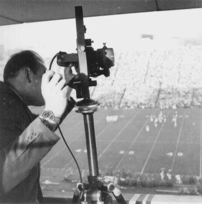Ric Sanderson checking camera during football game at Stoll Field