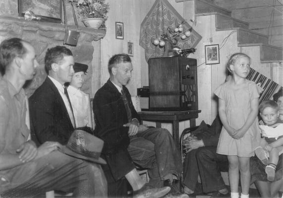 People gathered around radio at Listening Center #11 (Cordia) in Knott County, KY