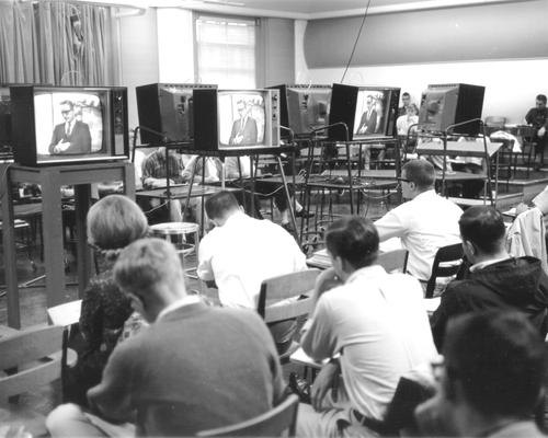 Students in Studio A, watching a professor on TV monitors provided by General Electric