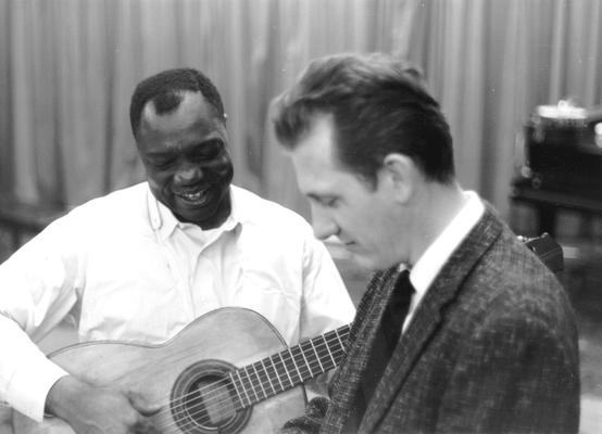 African-American man with guitar, unidentified man