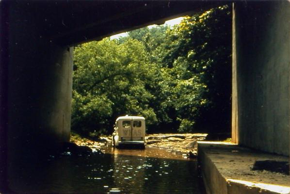 WHAS truck driving under bridge on water-covered road