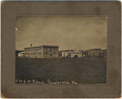 The Hazel Green Campus on Harrison Heights. The buildings from left to right were: 1. A faculty cottage, 2. The Helen E. Moses Memorial boys dormitory, 3. In the background with porches, the Sarah K. Yancey Home 4. In the center foreground is the Ford Industrial Arts Building, 5. A water tower, 6. Pearre Hall