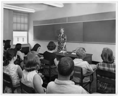 McLaughlin, professor of Journalism standing and lecturing to her class