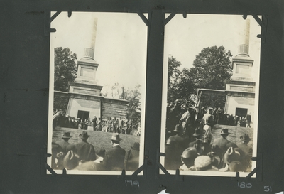 a building in the background, a man appears to be speaking, men in uniforms behind him a crowd watching; appears to be the same scene and people as in image #179, but taken from a different angle