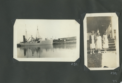 a ship that is docked; 3 women standing at the bottom of porch steps