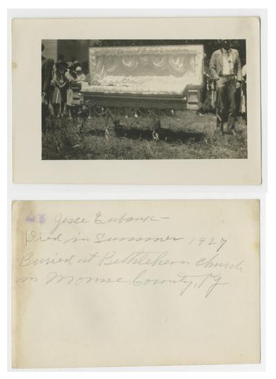 Unidentified persons standing around open casket with corpse of Jesse Eubank, note on back reads Jesse Eubank - died in summer 1927 buried at Bethlehem Church in Monroe County, Ky