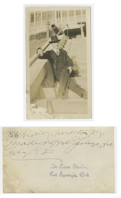 Rowland G. Railey sitting on steps with arm wrapped around railing
