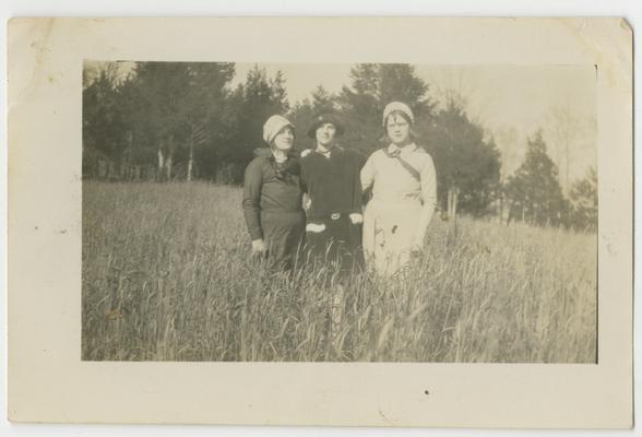 Three unidentified women in a field