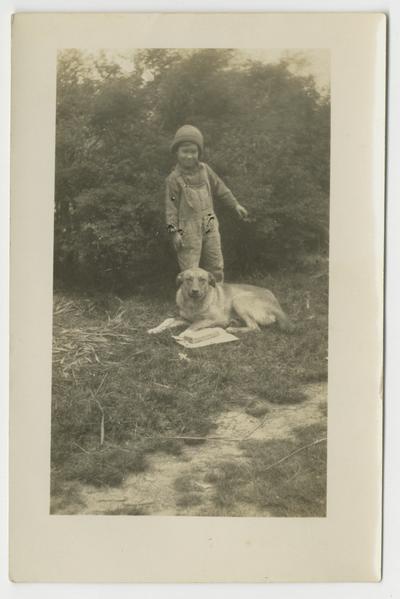 Unidentified young child and dog