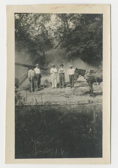 Unidentified man standing near a drilling rig