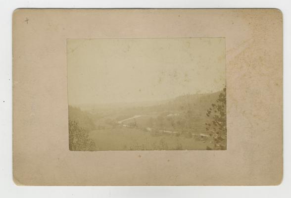 Road, mountains, and sky outside Frankfort; Distant view of Frankfort and Benson Valley, taken from the Flat Creek Rd by Paul, Sept. 1886 written in ink on back