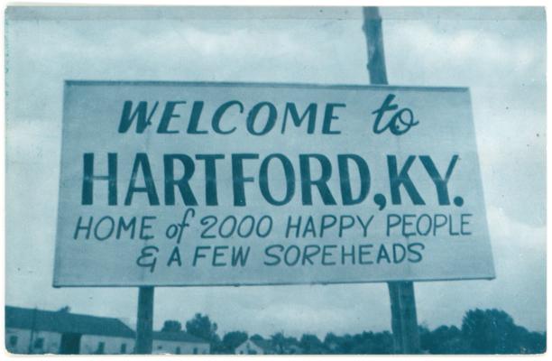 Welcome to Hartford, KY. Home of 2000 Happy People & A Few Soreheads. (Printed verso reads: 