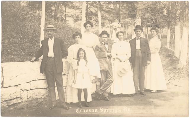 Grayson Springs. [Men and Women Standing in Front of Man-Made Rock Ledge]