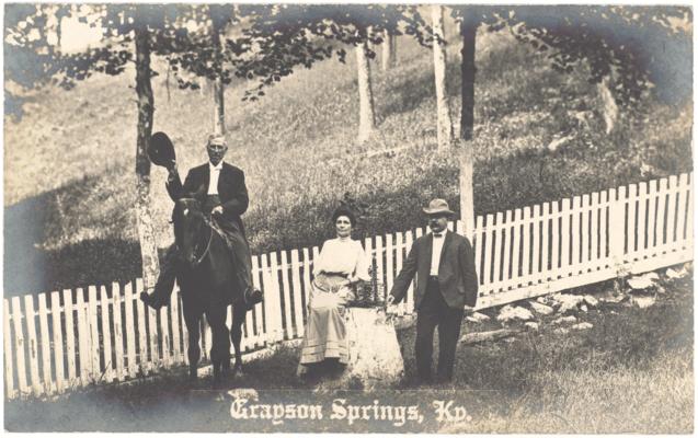 Grayson Springs. [Two Men, One on a Horse, and a Woman in Front of a Picket Fence]