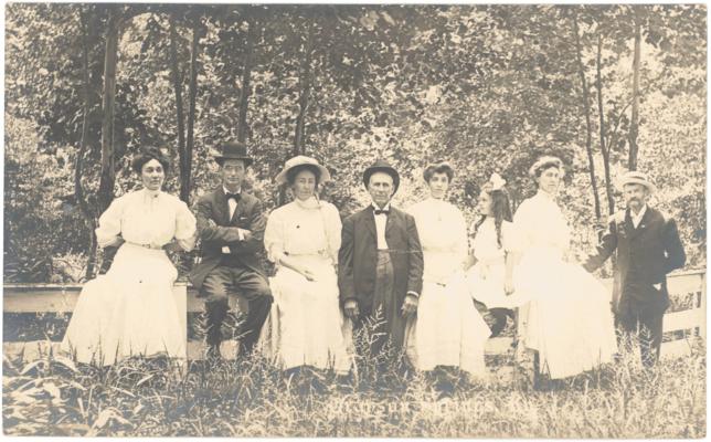 Grayson Springs. [Eight People Sitting On Rail Fence]