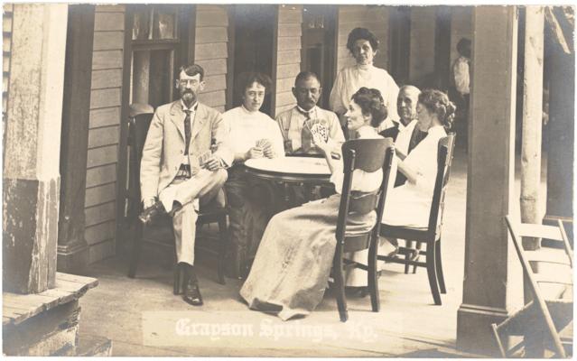 Grayson Springs. [Men And Women Sitting Around Table On Hotel Porch Playing Cards]