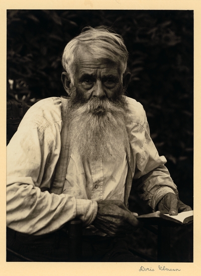 Christopher Lewis; Preacher; Wooton, Kentucky.  Elderly, bearded man in suspenders, seated with book
