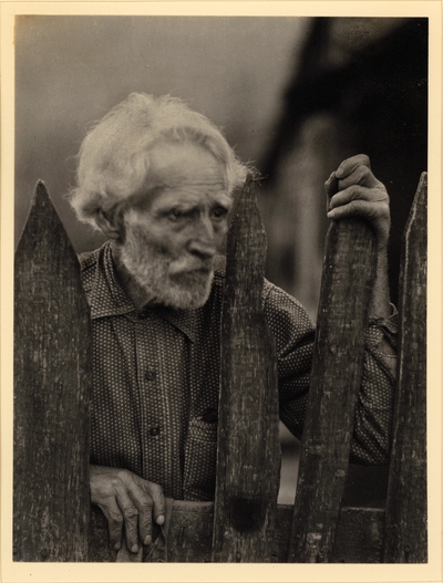 Nick Barton, Civil War veteran, d. May 1928.  Elderly, bearded man in polka-dot shirt, standing behind fence SAME AS PA70M1 #7