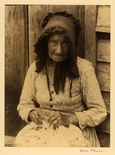 Aunt Didie Netherly; Lacemaker, weaver; Grassy Valley, Tennessee.  Elderly woman in bonnet, seated, making lace