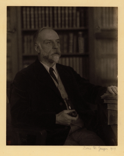Russell Hibbs,  Prof. of orthopedic surgery, Columbia.  Elderly, bearded man in suit and tie, holding pipe, seated in chair with bookshelves in background