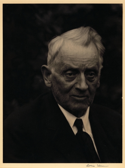 Head shot of elderly man with short beard, suit, and tie