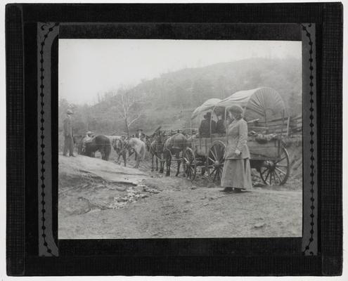 Unidentified group of men and women with a horse drawn wagon