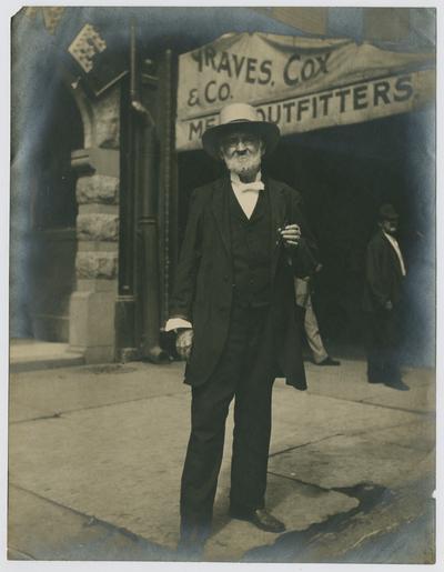 John Henry Neville, standing in front of Graves. Cox & Co. Store in Lexington, Kentucky