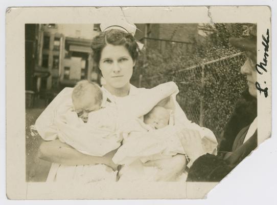 Patients, infants, unknown (being held by a nurse)